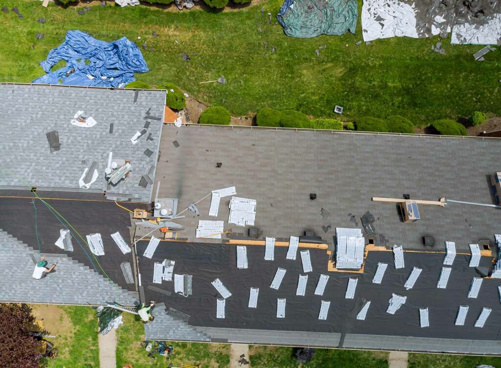 aerial view of roof construction repairman on a roof