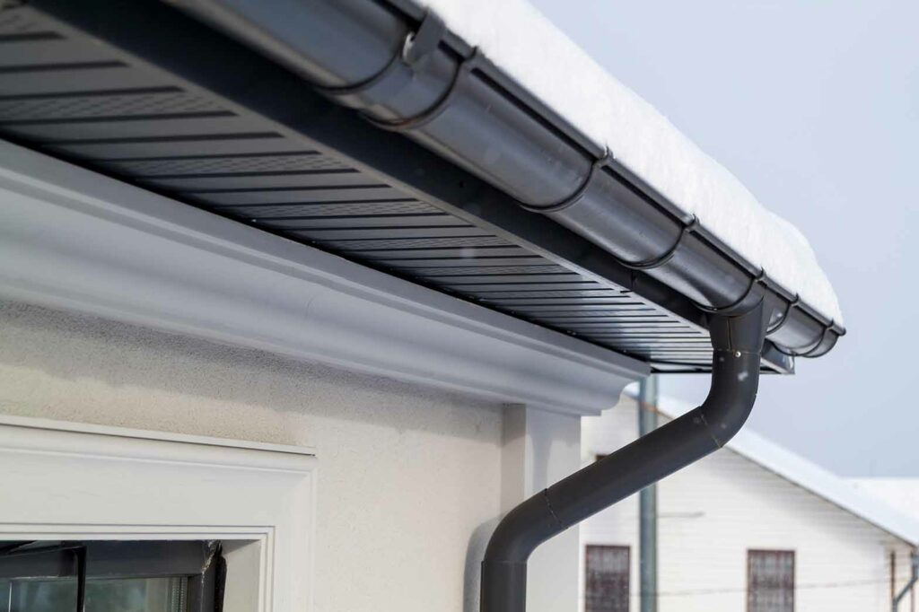 corner of the house with new gray metal tile roof